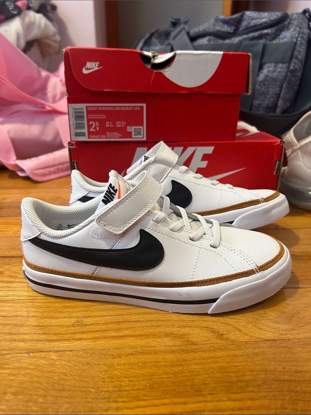 Nike Kids White Sneakers with Black Swoosh and Tan Trim